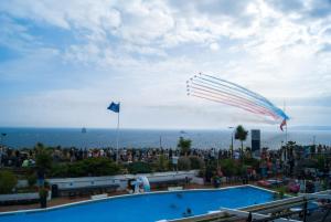 a kite flying in the sky over a pool at Cumberland Hotel - OCEANA COLLECTION in Bournemouth