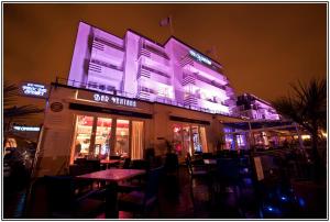 a restaurant with purple lights on the side of a building at Cumberland Hotel - OCEANA COLLECTION in Bournemouth
