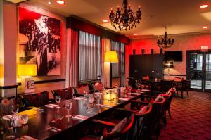 a dining room with a long table and chairs at Cumberland Hotel - OCEANA COLLECTION in Bournemouth