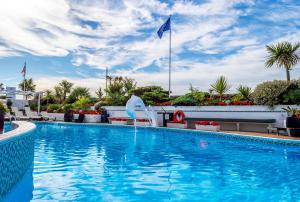 a swimming pool at a hotel with a sky background at Cumberland Hotel - OCEANA COLLECTION in Bournemouth