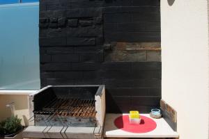 a grill with a red plate on top of it at Apartamento Remos in Sesimbra