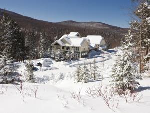 a house on a hill covered in snow at Club Wyndham Smugglers' Notch Vermont in Jeffersonville