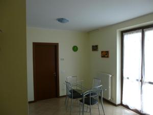 a dining room with chairs and a table and a window at La Cornice del Garda in Cavalcaselle +22 photos