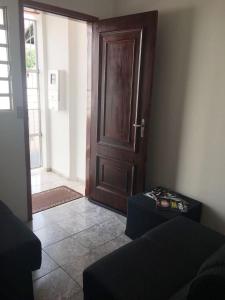 a room with a door and a room with a couch at Residencias JAC in Paraguaçu Paulista