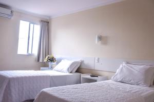 Ένα ή περισσότερα κρεβάτια σε δωμάτιο στο Prime Hotel