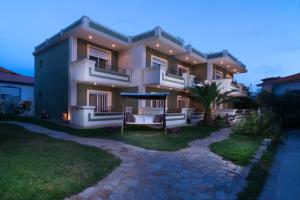 a large house with a pathway in front of it at Villa Irida in Potos