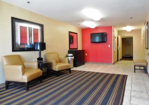 a waiting room with chairs and a flat screen tv at Extended Stay America Select Suites - Atlanta - Alpharetta - Northpoint - East in Alpharetta