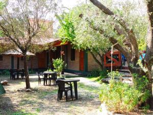 a group of tables and chairs in front of a house at Alma Mora in Merlo