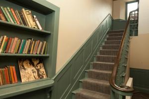 a staircase with bookshelves in a library at The Rooms at Bardons in Kilcullen