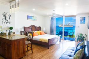 a bedroom with a bed and a living room at Montego Bay Club Apartments in Montego Bay