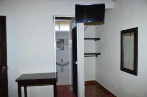 a small bathroom with a sink and a mirror at Hospedaje y Camping Buena Vista in San Agustín