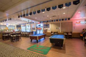 a restaurant with ping pong tables and a bar at Brawley Inn in Brawley