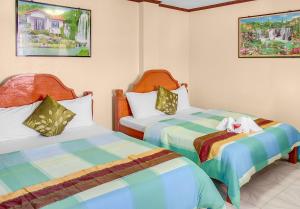 two beds in a room with two beds sidx sidx sidx at Blue Corals Beach Resort in Malapascua Island +72 photos