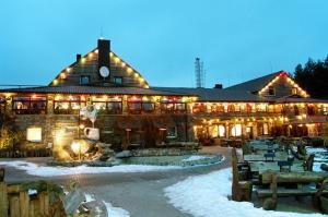 a large building with lights on it in the snow at Elija apartments Palanga (Sventoji) in Palanga