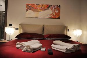 a bed with two towels and two remote controls on it at L'Airone Country House in SantʼElia Fiumerapido