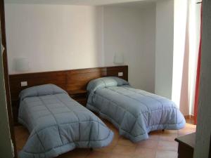 Łóżko lub łóżka w pokoju w obiekcie Agriturismo Les Hiboux
