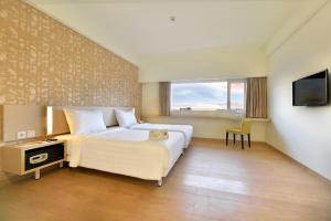 Ένα ή περισσότερα κρεβάτια σε δωμάτιο στο Whiz Prime Hotel Sudirman Cilacap