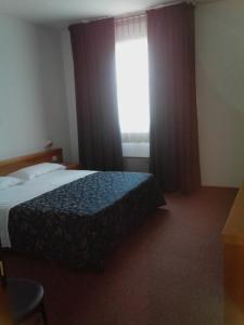 Postel nebo postele na pokoji v ubytování Hotel Niki