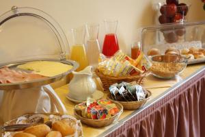 a buffet with baskets of bread and other foods at Hotel Europa in Naples