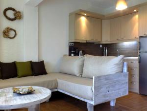 a living room with a couch and a table at Christaras Apartments in Vourvourou
