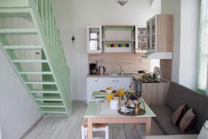 a small kitchen with a table and a staircase at Villa Klytia in Halki