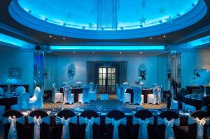a banquet hall with tables and chairs in a room at Cumberland Hotel - OCEANA COLLECTION in Bournemouth
