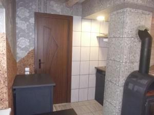 a small kitchen with a stove and a door at Nakvynė Rokiškyje in Rokiškis +50 photos