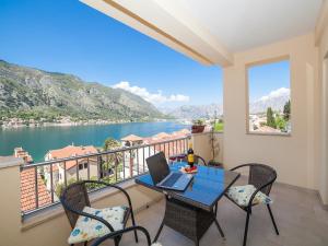 a balcony with a table with a laptop on it at Apartments Castello in Kotor