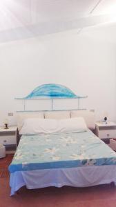 サンタ・テレーザ・ガッルーラにあるAzienda Agricola Li Nalboniのベッドルーム1室(青い天蓋付きのベッド1台付)