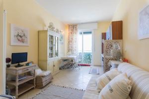 a living room with a couch and a television at La Casa di Pepe in Pietra Ligure