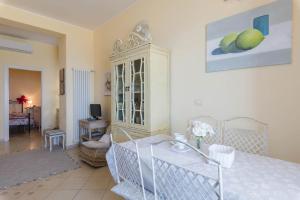 a living room with a table and a cabinet at La Casa di Pepe in Pietra Ligure