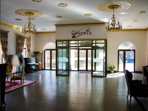 a lobby of a shopping center with a revolving door at Sputnik Hotel Batumi in Batumi +123 photos