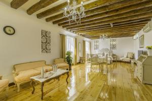 a living room with a couch and a table at Oriente Palace Apartments in Madrid