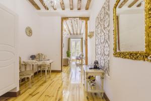 a room with a table and a mirror on the wall at Oriente Palace Apartments in Madrid