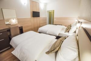 Postel nebo postele na pokoji v ubytování Hotel Požega