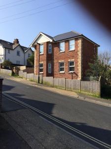 a brick house on the side of a street at The Custards in Shanklin