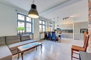 a living room with a couch and a table at Apartment Mariacka Exclusive in Gdańsk