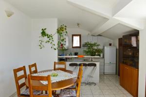 a kitchen with a table and chairs in a room at Apartment Juras in Opatija