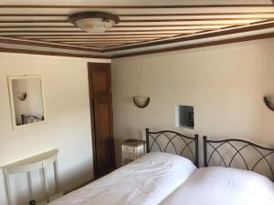 a bedroom with a bed and a coffered ceiling at Elafotopos Hotel in Elafotopos