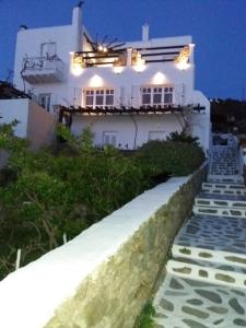 a white house with lights on the side of it at Anchor Αpartments in Mýkonos City