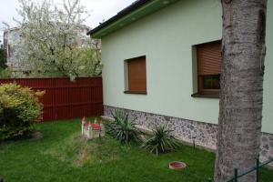 a green and white house with a white fence at Vila Ria in Bratislava
