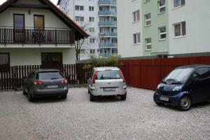 two cars are parked in front of a building at Vila Ria in Bratislava
