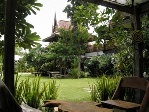 a view of a garden from the porch of a house at Baan Thai House in Phra Nakhon Si Ayutthaya