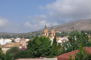 a view of a city with a church in the background at Casa Tamayo in Órgiva