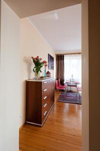 a living room with a dresser and a dining room at Twardowski Apartament in Krakow