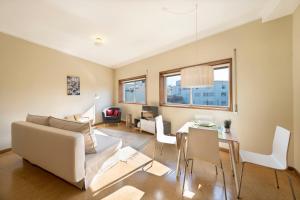 a living room with a couch and a table at BmyGuest - Santa Catarina Light Apartment in Porto