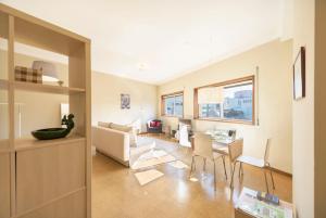 a living room with a couch and a table at BmyGuest - Santa Catarina Light Apartment in Porto +22 photos