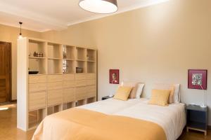 a bedroom with two beds and a large cabinet at BmyGuest - Santa Catarina Light Apartment in Porto
