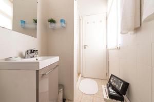 a bathroom with a sink and a toilet and a shower at BmyGuest - Santa Catarina Light Apartment in Porto