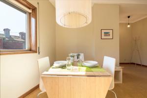 a dining room with a table with chairs and a window at BmyGuest - Santa Catarina Light Apartment in Porto